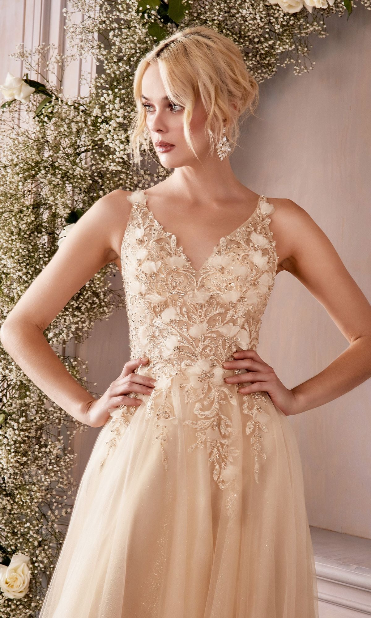 A woman poses with hands on hips in the Ladivine CD0181 Glitter Tulle Illusion Prom Dress, surrounded by baby's breath and white roses.